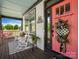 Inviting front porch with rocking chairs, welcome sign, and decorative wreath on the pink front door at 909 Herrons Ferry Rd, Rock Hill, SC 29730