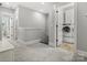 Hallway featuring access to the upstairs laundry room with modern machines at 909 Herrons Ferry Rd, Rock Hill, SC 29730