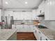 Modern kitchen featuring white cabinets, granite countertops, and stainless steel appliances at 909 Herrons Ferry Rd, Rock Hill, SC 29730