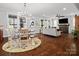 Open living and dining area featuring hardwood floors, natural light, and a cozy fireplace at 909 Herrons Ferry Rd, Rock Hill, SC 29730