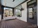 Relaxing screened-in porch with a hanging swing, TV, fan, grill, and wood flooring at 909 Herrons Ferry Rd, Rock Hill, SC 29730