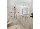 Modern tile shower with a built-in seat, shower wand, overhead shower head, and inset shelves at 909 Herrons Ferry Rd, Rock Hill, SC 29730