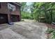 Long concrete driveway leading to a brick home with attached garage and a basketball hoop, surrounded by lush greenery at 9300 Surrey Rd, Mint Hill, NC 28227