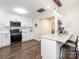 Updated kitchen with white cabinets, stainless steel appliances, granite countertops, and a breakfast bar at 9300 Surrey Rd, Mint Hill, NC 28227