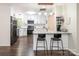 Open concept kitchen with stainless appliances, granite countertops, and a breakfast bar overlooking the living area at 9300 Surrey Rd, Mint Hill, NC 28227