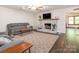 Inviting living room with a painted brick fireplace, hardwood floors, and comfortable seating at 9300 Surrey Rd, Mint Hill, NC 28227