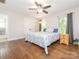 A spacious main bedroom featuring hardwood floors, a ceiling fan, and lots of natural light, creating a relaxing space at 9300 Surrey Rd, Mint Hill, NC 28227