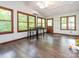 Bright sunroom with wood floors, large windows, skylights, and a small table perfect for enjoying views of the outdoors at 9300 Surrey Rd, Mint Hill, NC 28227