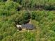 Stunning aerial view of a stately home nestled among mature trees with a well-manicured lawn at 1010 Arabian Farm Rd, Clover, SC 29710