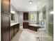 Full bathroom featuring a walk-in shower, dark wood cabinets, granite counters, and tile flooring at 1010 Arabian Farm Rd, Clover, SC 29710
