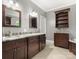 Spacious bathroom showcasing a double vanity with granite countertop, dark wood cabinets and tile flooring at 1010 Arabian Farm Rd, Clover, SC 29710