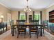 Formal dining room featuring a wooden table, chandelier, and windows with wooded views at 1010 Arabian Farm Rd, Clover, SC 29710