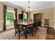 Elegant dining room featuring a wooden table, chandelier, and natural light from the windows at 1010 Arabian Farm Rd, Clover, SC 29710
