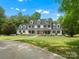 A beautiful house is situated on a large lot with mature trees and a winding driveway at 1010 Arabian Farm Rd, Clover, SC 29710
