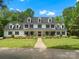 Stately two-story home with black shutters, dormer windows, and a welcoming front porch at 1010 Arabian Farm Rd, Clover, SC 29710