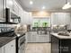 Charming kitchen featuring stainless steel appliances, granite counters, and white custom cabinets at 1010 Arabian Farm Rd, Clover, SC 29710
