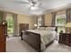 Bright main bedroom with a large bed, neutral colors, and large windows overlooking the yard at 1010 Arabian Farm Rd, Clover, SC 29710