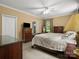 Relaxing main bedroom with neutral colors, warm lighting, and dark wood furniture at 1010 Arabian Farm Rd, Clover, SC 29710