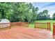 A stained backyard deck overlooks the grassy backyard and storage shed at 10945 Wiltshire Ln, Charlotte, NC 28262