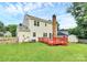 Backyard features a wood deck, a brick chimney, and a storage shed at 10945 Wiltshire Ln, Charlotte, NC 28262