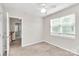 Neutral bedroom with a ceiling fan and natural light with hall access at 10945 Wiltshire Ln, Charlotte, NC 28262