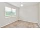 Carpeted bedroom with neutral walls, a ceiling fan and natural light at 10945 Wiltshire Ln, Charlotte, NC 28262