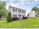 Charming two-story home featuring a well-maintained lawn and classic black shutters at 10945 Wiltshire Ln, Charlotte, NC 28262