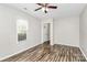 Inviting living room featuring hardwood floors, a window, and a ceiling fan for a bright and airy atmosphere at 10945 Wiltshire Ln, Charlotte, NC 28262