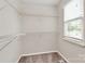 Walk-in closet with built-in shelving, providing ample storage space and organization at 10945 Wiltshire Ln, Charlotte, NC 28262