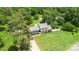Aerial view of a home with a long driveway, beautiful lawn, and mature trees at 1104 Colony Ct, Gastonia, NC 28056
