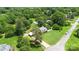 Aerial view of the property with a lush green lawn, mature trees, and a car port at 1104 Colony Ct, Gastonia, NC 28056