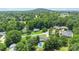 Home and inground pool in a neighborhood with rolling hills and mature trees in the background at 1104 Colony Ct, Gastonia, NC 28056
