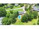 Aerial view of home, pool, and neighborhood with mature trees at 1104 Colony Ct, Gastonia, NC 28056