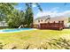 Expansive backyard featuring a sparkling pool, grassy area, and inviting deck for outdoor enjoyment at 1104 Colony Ct, Gastonia, NC 28056