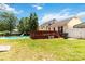 Well-maintained backyard boasts a refreshing pool, charming deck, and lush green lawn at 1104 Colony Ct, Gastonia, NC 28056