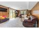 Inviting finished basement featuring wood paneling, plush carpeting, and sliding glass doors at 1104 Colony Ct, Gastonia, NC 28056