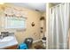 Traditional bathroom with vanity, tile floor, shower with curtain, and decorative window treatment at 1104 Colony Ct, Gastonia, NC 28056