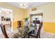 Formal dining room with a modern glass table, chandelier, and elegant decor at 1104 Colony Ct, Gastonia, NC 28056