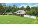 Beautiful home exterior showing a spacious lawn, mature trees, and a convenient car port at 1104 Colony Ct, Gastonia, NC 28056