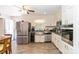 Bright kitchen with stainless steel appliances, white cabinetry, and hardwood floors at 1104 Colony Ct, Gastonia, NC 28056