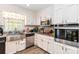 Updated kitchen featuring stainless steel appliances, granite countertops and white cabinetry at 1104 Colony Ct, Gastonia, NC 28056
