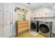 Laundry room featuring modern Samsung washer and dryer with cabinets and a window at 1104 Colony Ct, Gastonia, NC 28056