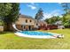 Backyard view of a large pool, slide, patio deck, and home exterior at 1104 Colony Ct, Gastonia, NC 28056