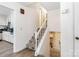 Bright stairway featuring carpeted steps, white banister, and modern flooring at 1104 Colony Ct, Gastonia, NC 28056