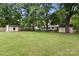 Expansive green backyard featuring an outbuilding, mature trees, and a well-maintained lawn at 1109 S Highland Ave, Landis, NC 28088