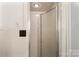 Tiled bathroom featuring a glass door shower with a neutral color scheme at 1109 S Highland Ave, Landis, NC 28088
