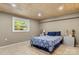 Cozy bedroom with wood plank ceiling, neutral walls, and large window letting in natural light at 1109 S Highland Ave, Landis, NC 28088