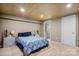 Comfortable bedroom with wood plank ceiling, neutral walls, and a glimpse into another room at 1109 S Highland Ave, Landis, NC 28088