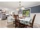 Open dining area features blue accent wall, white wainscoting, and kitchen access at 1109 S Highland Ave, Landis, NC 28088