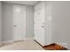 Neutral entryway featuring carpet, a secure front door, and access to rooms at 1109 S Highland Ave, Landis, NC 28088